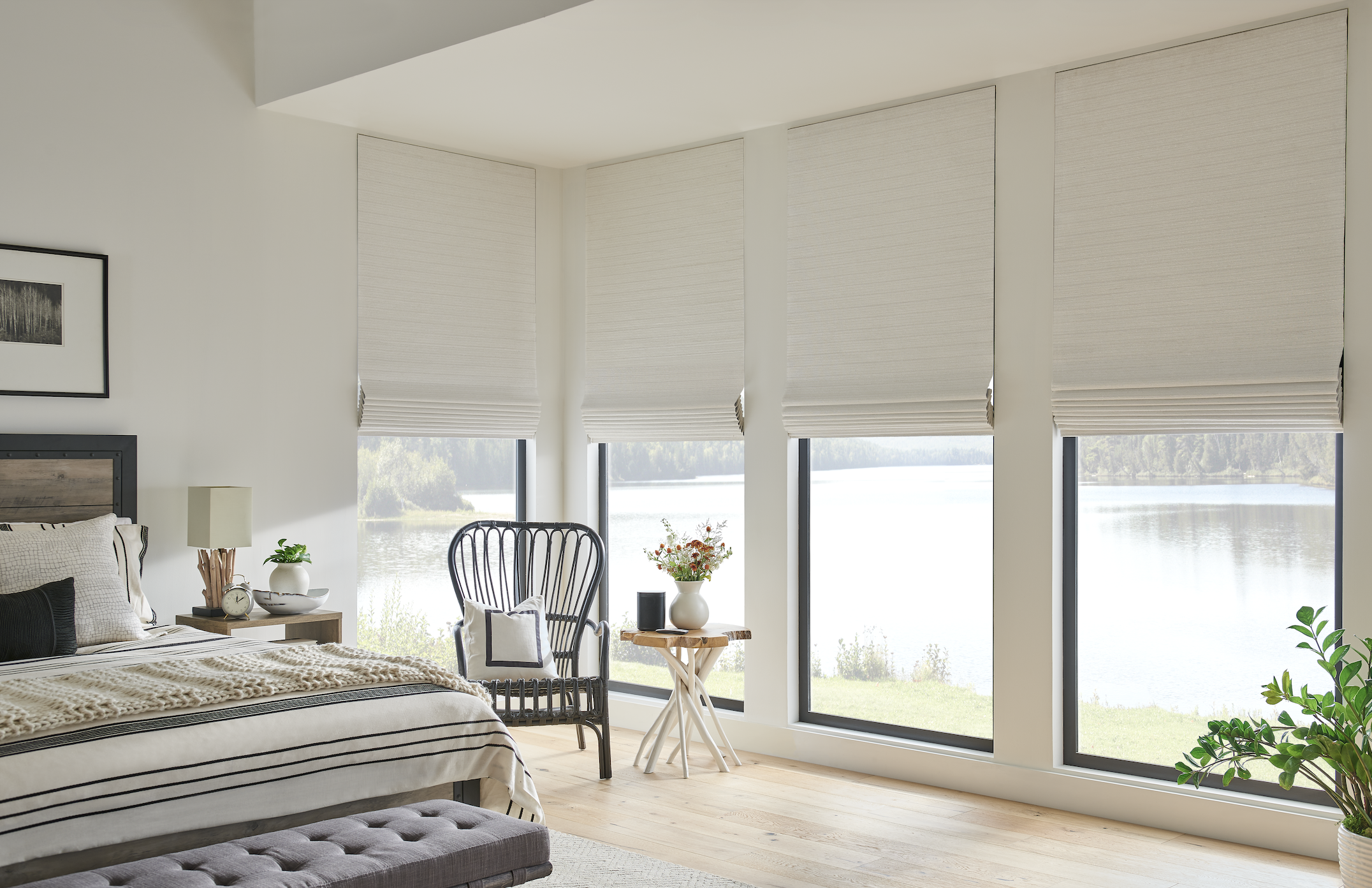 Natural woven shades over a lake view