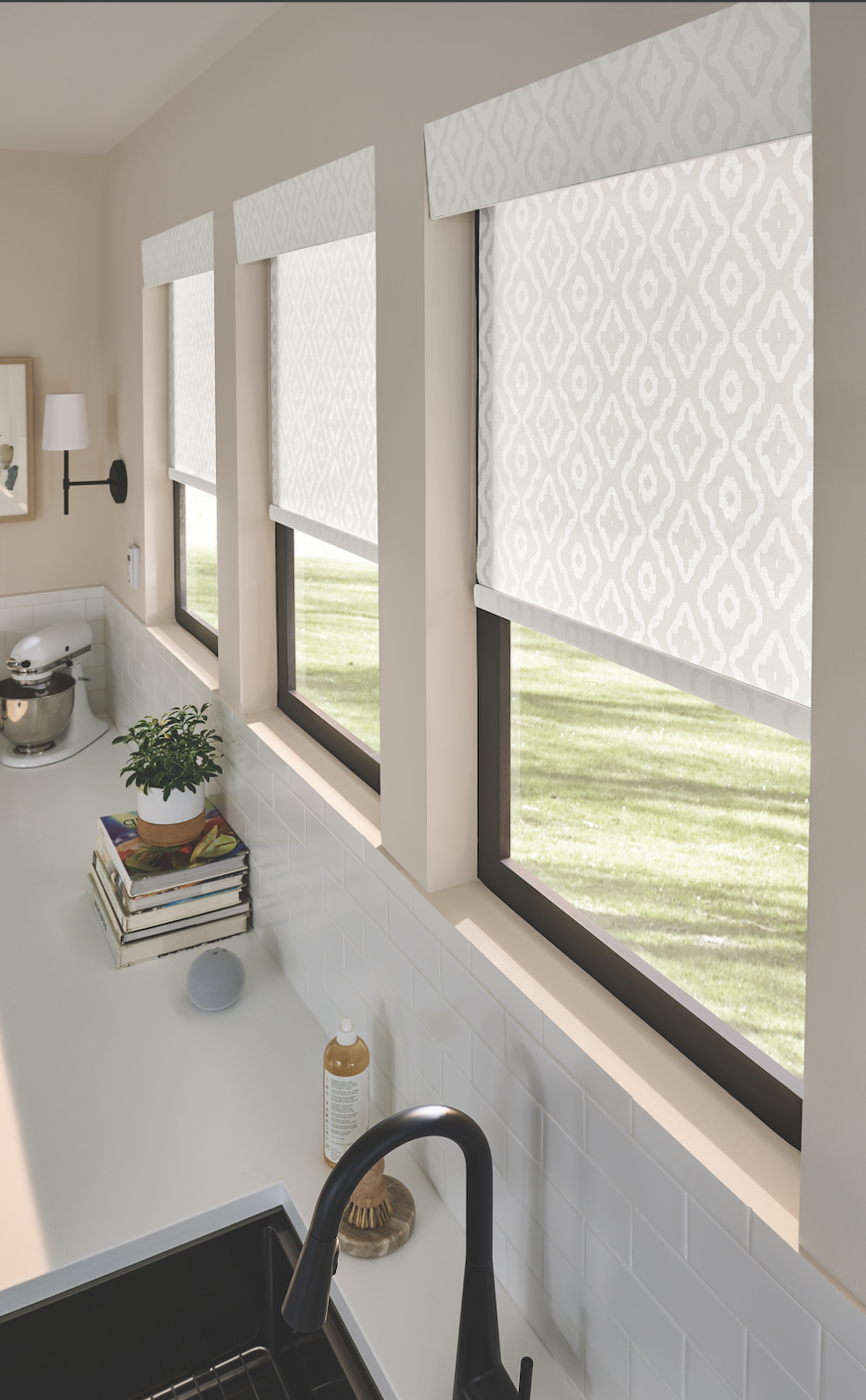 Patterned roller shades over a kitchen sink