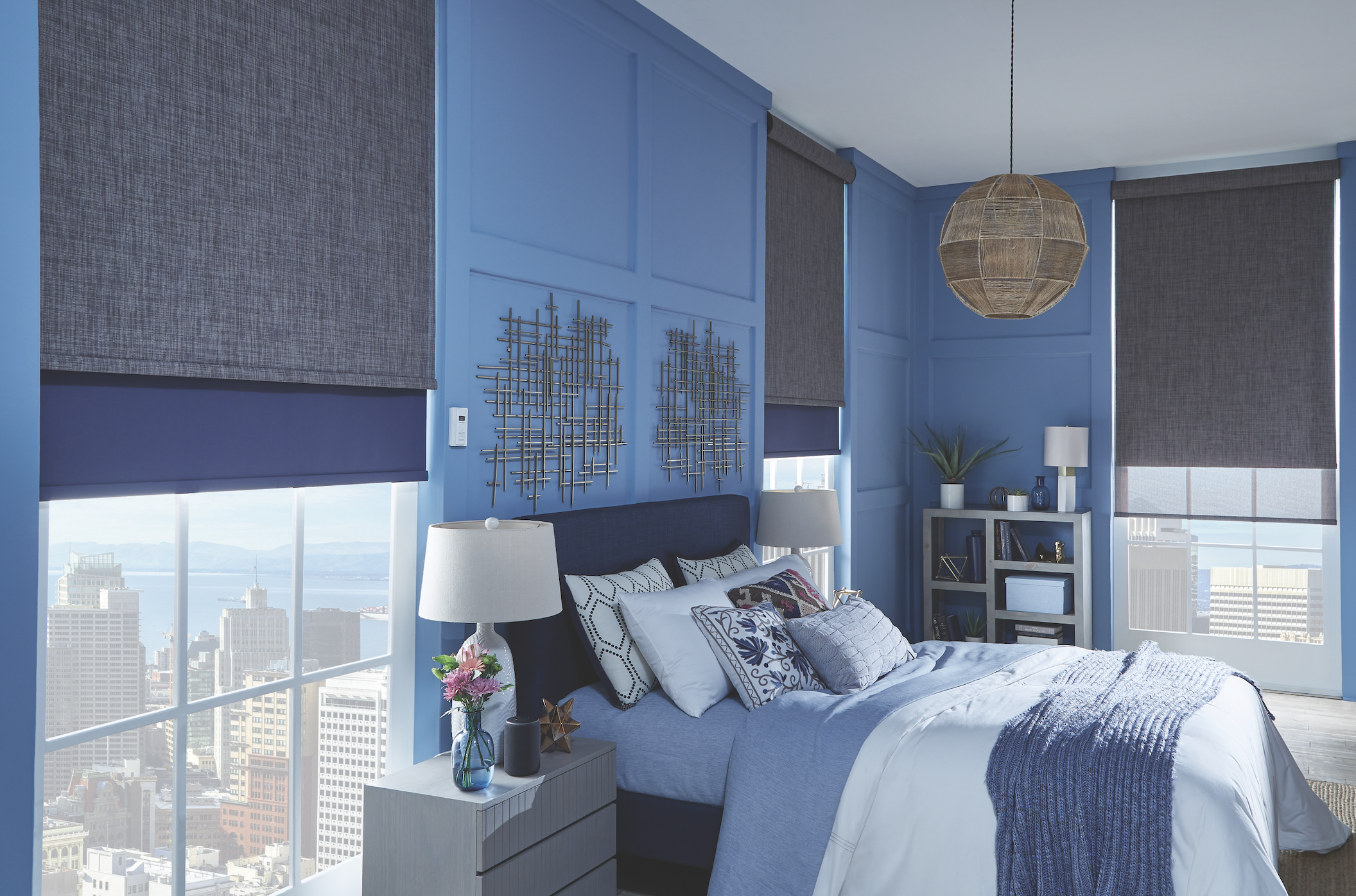 Roller shades in a city high-rise bedroom