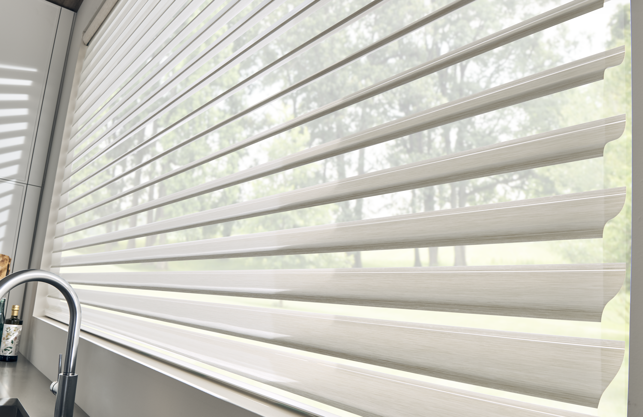 Sheer shade vanes filtering light over a kitchen sink