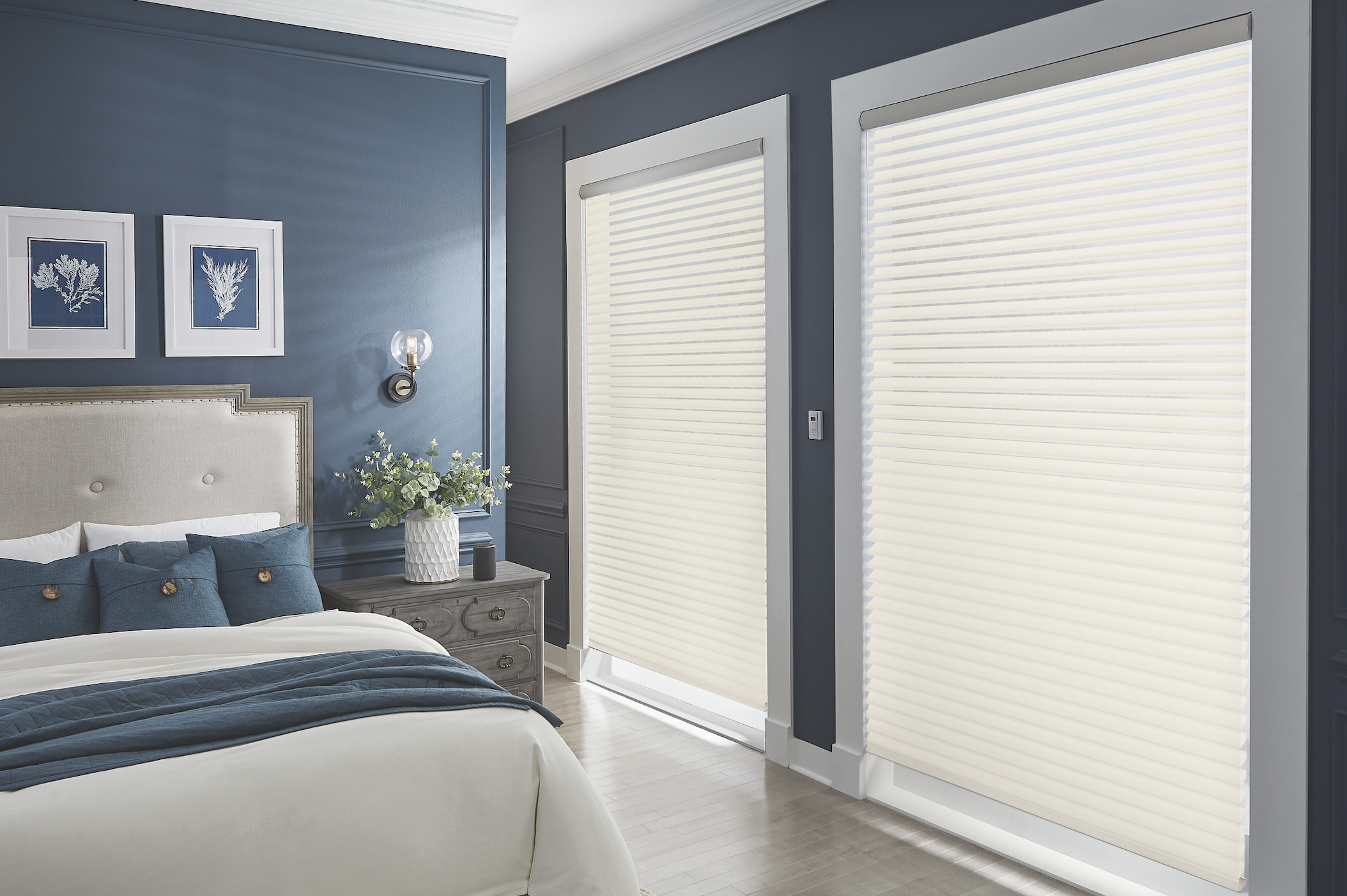 Cream sheer shades in a blue bedroom