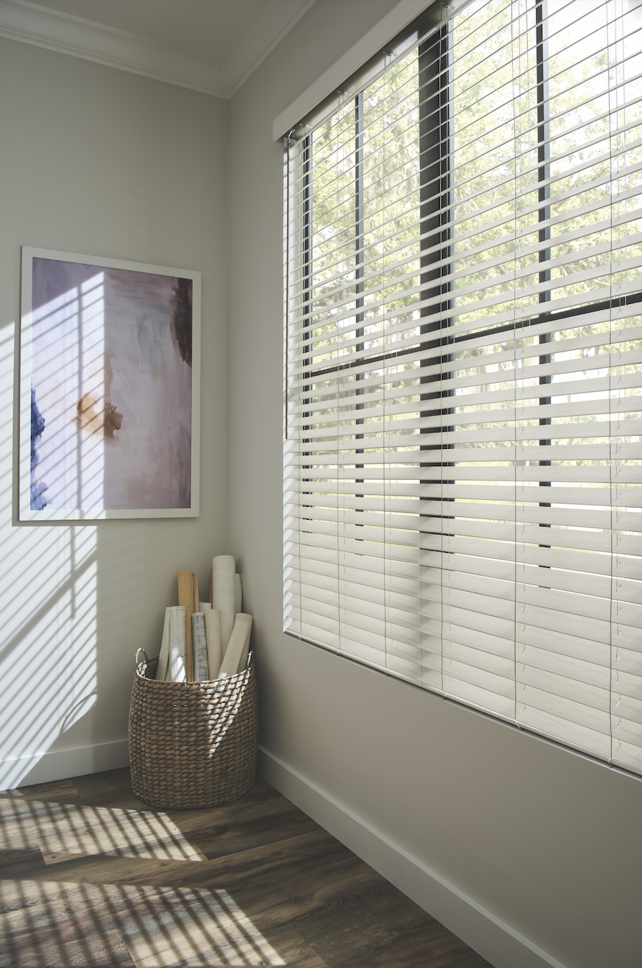 White faux wood blinds in a sunlit corner