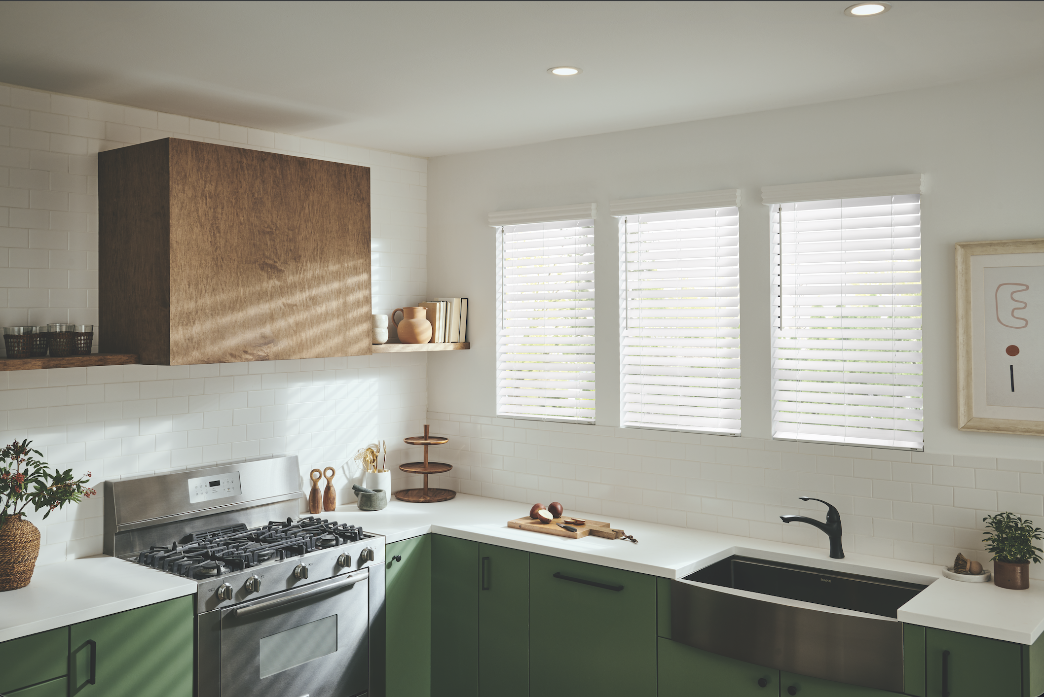White faux wood blinds in a green kitchen